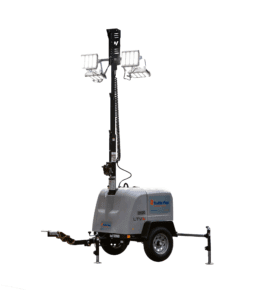 A portable light tower on a wheeled trailer with four bright floodlights mounted on a tall, extendable mast, stabilizing legs, and a hitch for towing.